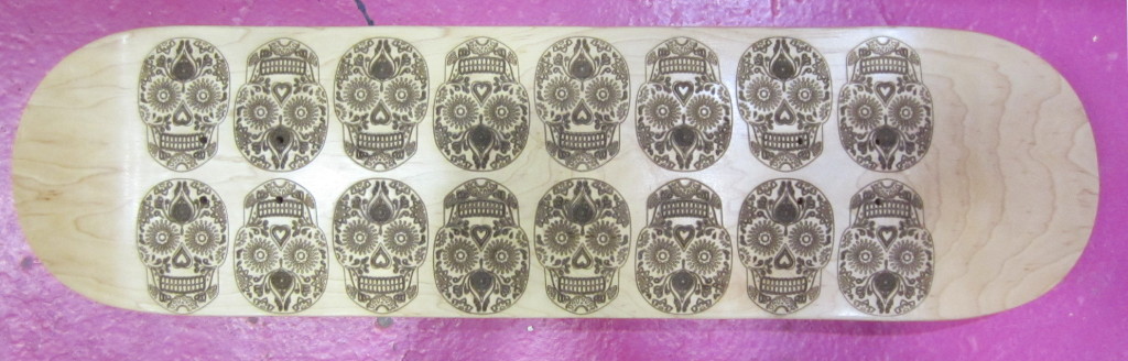 Natural deck with laser engraved sugar skull pattern
